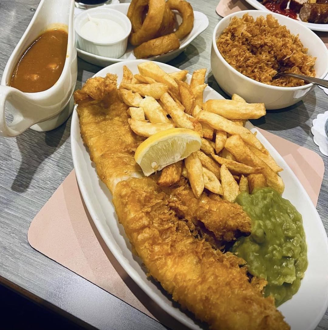 Traditional fish and chips with mushy peas, chips, onion rings and scraps at Ocean Fish Bar